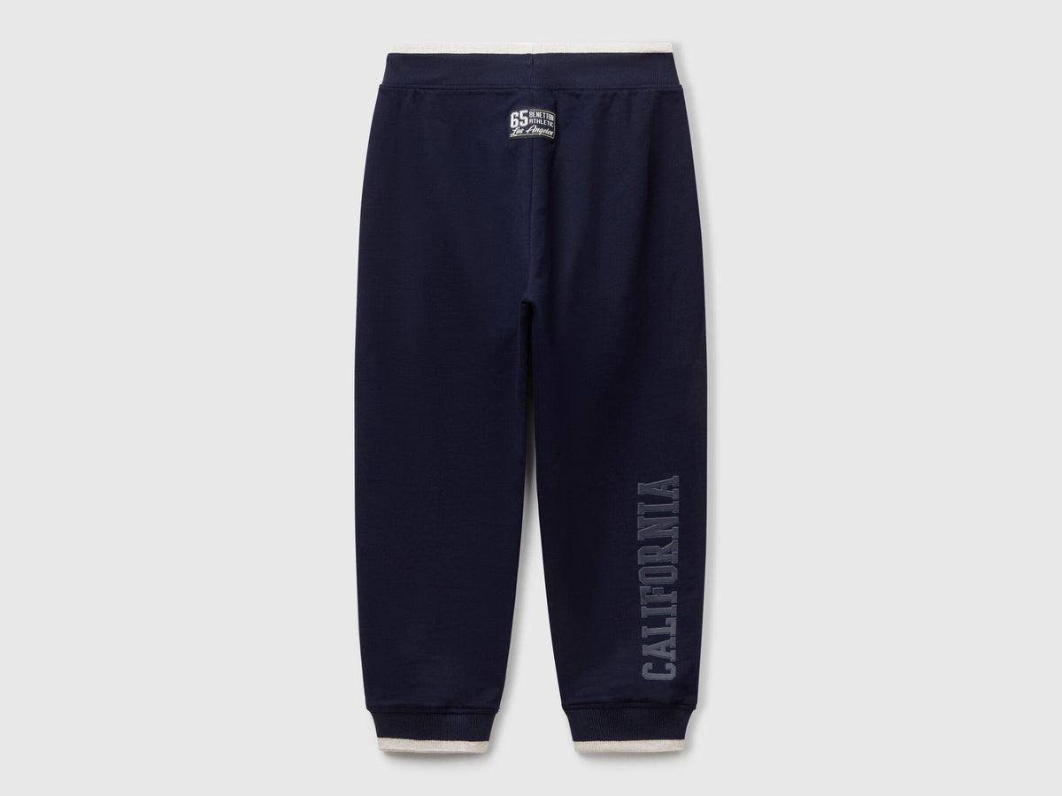 Back view of Benetton lightweight sweatpants with brand details