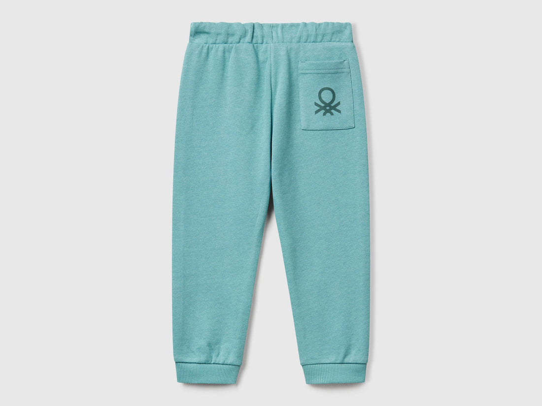 Back view of Benetton logo print trousers with certified organic detail