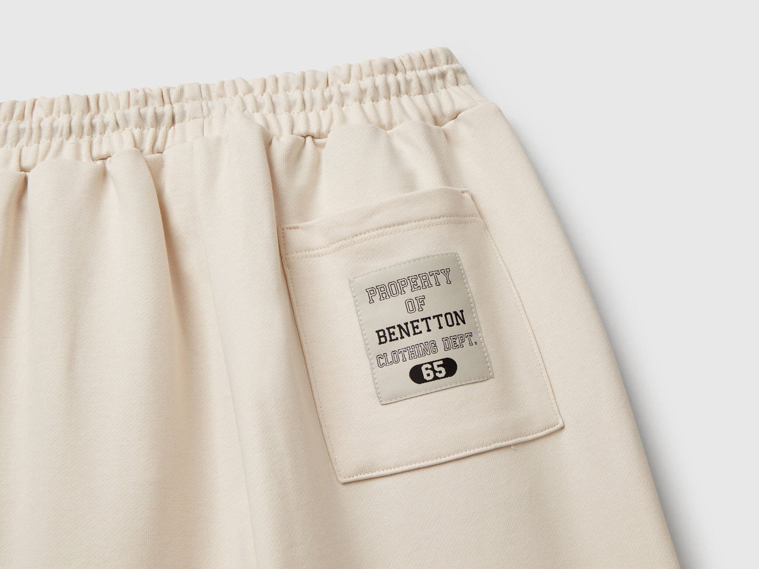 Benetton olive green cotton sweatpants side view showing piping accent