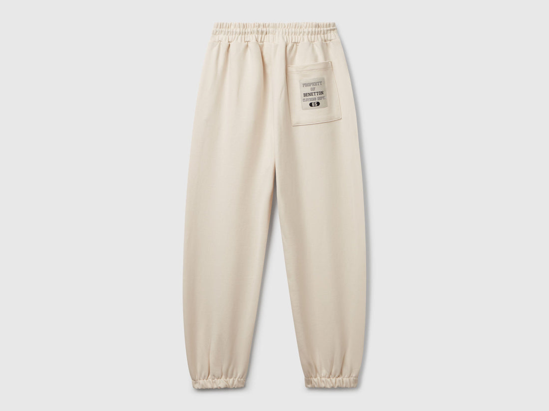Back view of Benetton sweatpants with patch pockets and piping