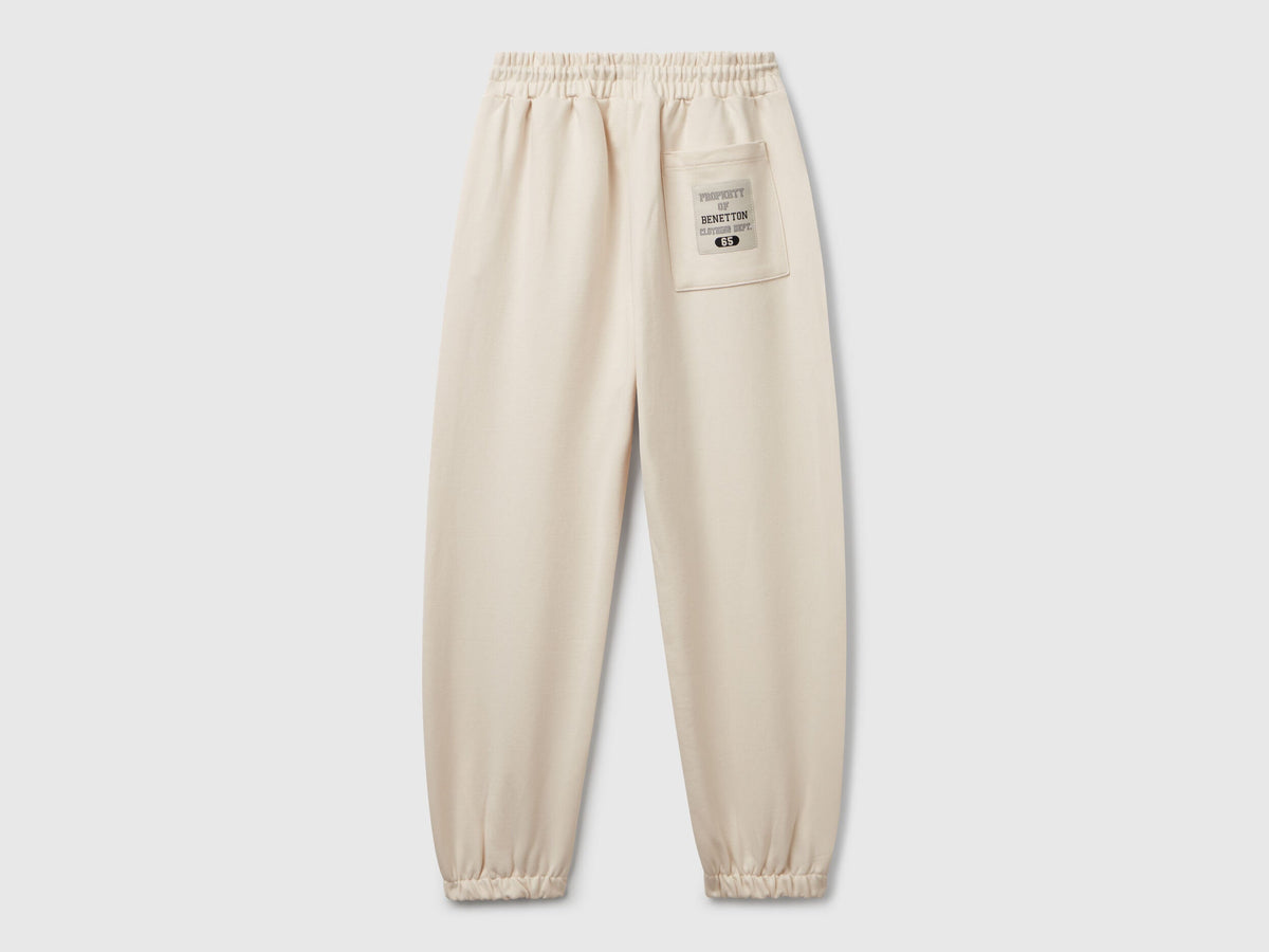 Back view of Benetton sweatpants with patch pockets and piping