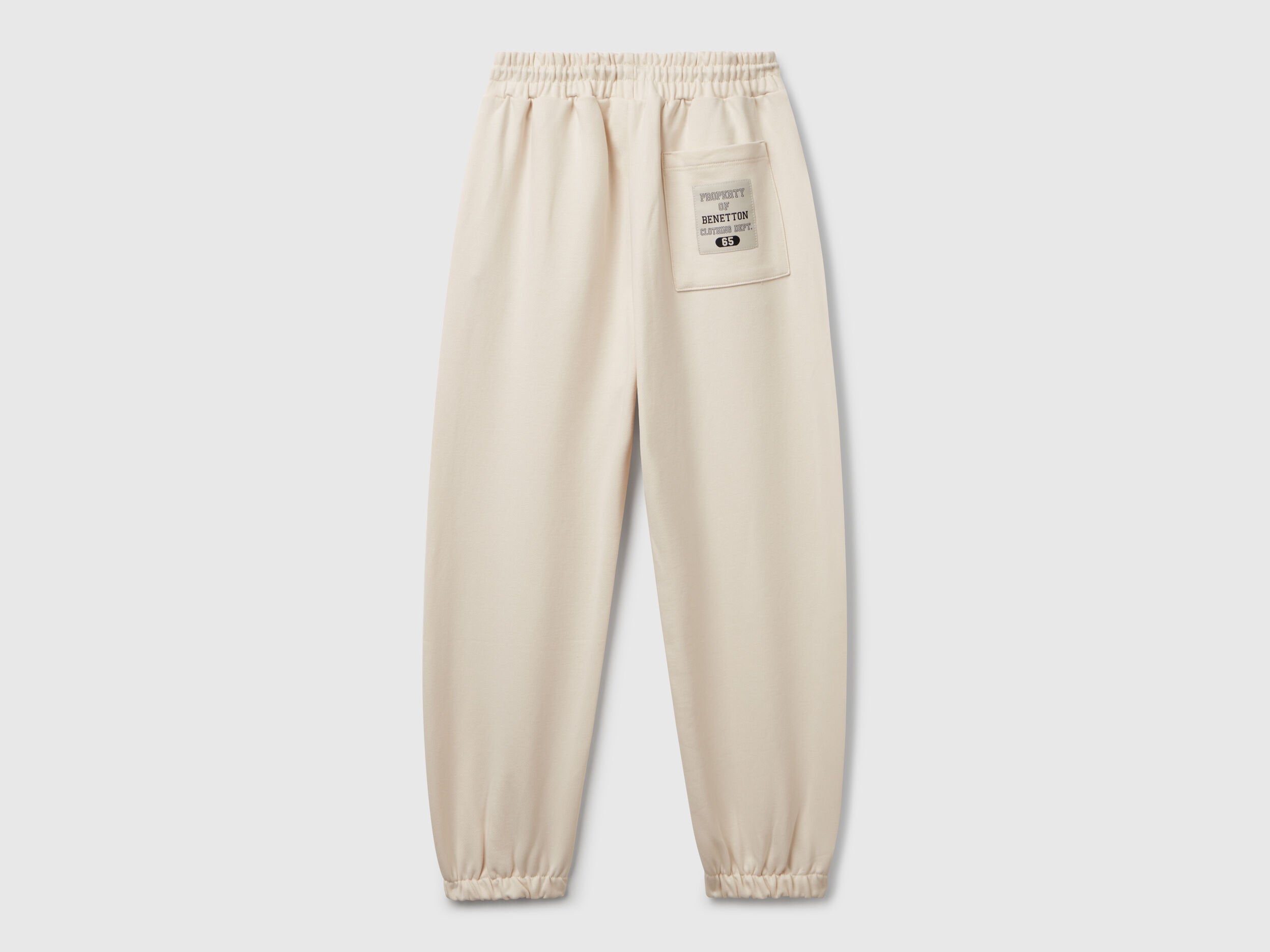 Back view of Benetton sweatpants with patch pockets and piping