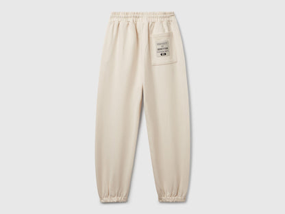 Back view of Benetton sweatpants with patch pockets and piping