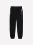 Front view of black clashing jogger sweatpants with a visible side stripe, designed for comfort and athletic style.