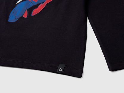 Close-up of black Marvel Spiderman long-sleeve T-shirt hem, showing the small brand tag detail.