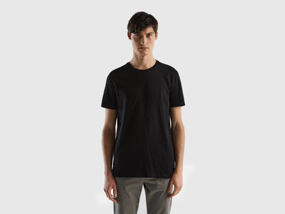 Male model wearing a classic black t-shirt, presented from the front, paired with casual pants.