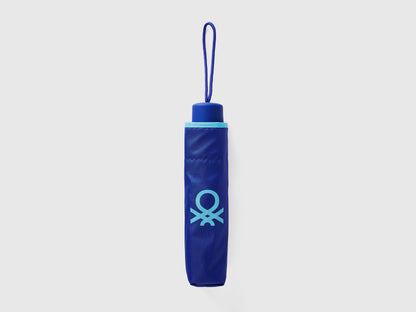 Folded blue Benetton umbrella, compact for portability.