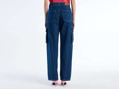 Back view of a woman wearing dark blue cargo trousers and pink heels. Wide leg, relaxed fit.