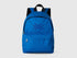 Front view of a vibrant blue nylon backpack with a prominent Benetton logo on the flap.