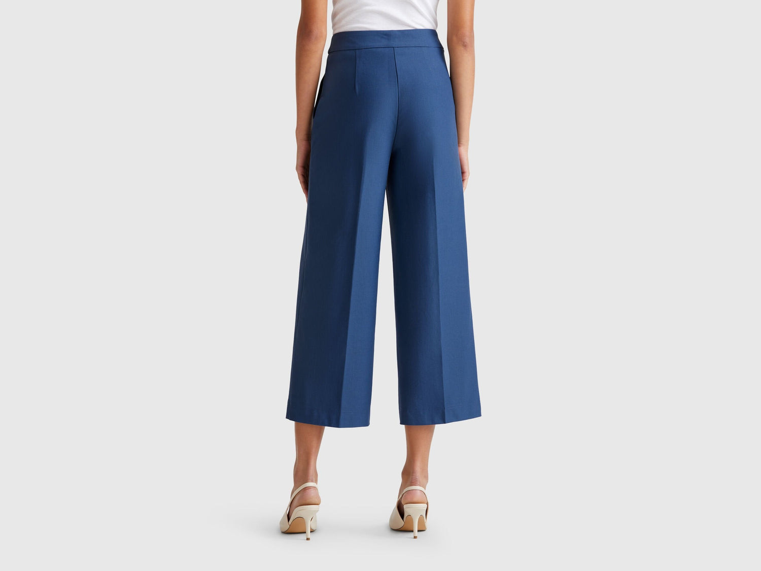 Back view of a female model wearing blue women&