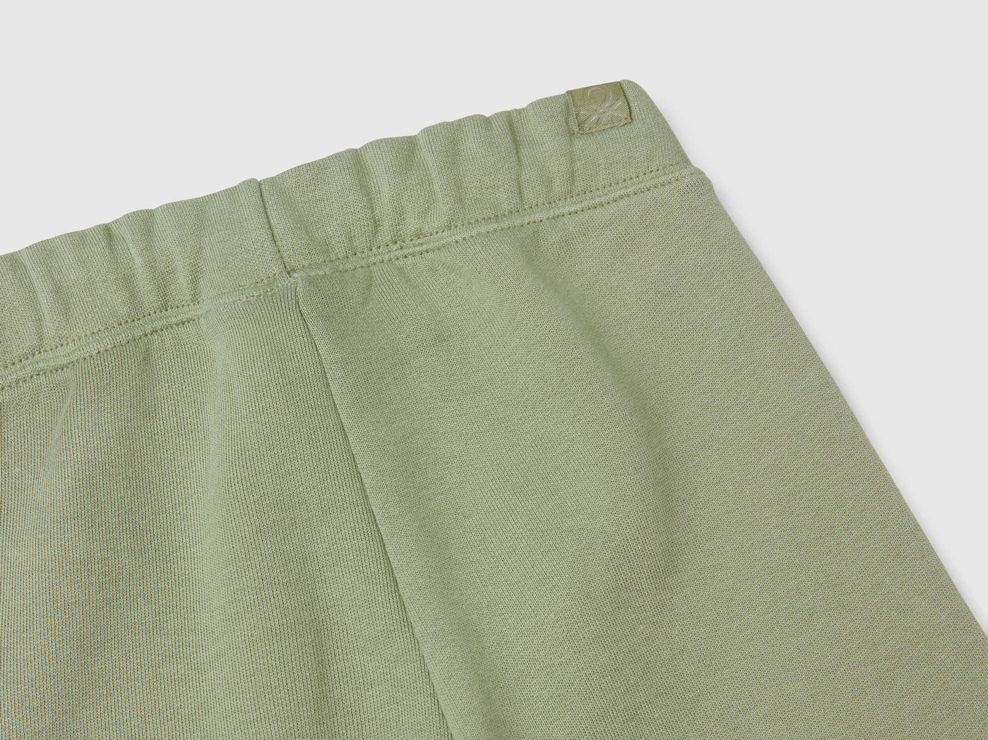 Close-up of the waistband and drawstring of the green boys&