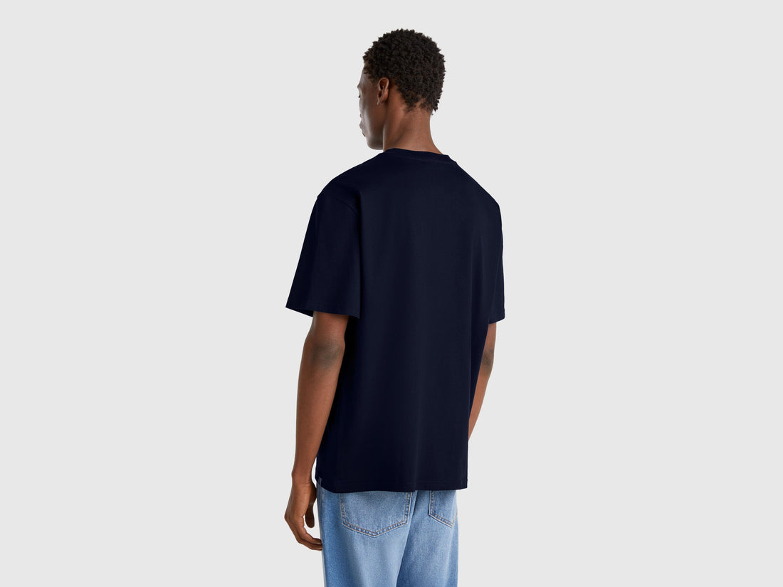 Back view of a dark blue oversized t-shirt. Simple, plain design for comfort and casual wear.