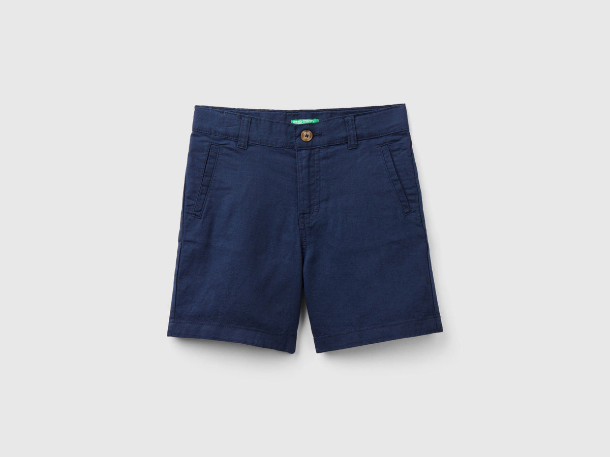  A full, flat lay shot of a pair of dark blue linen blend shorts, viewed from the front.