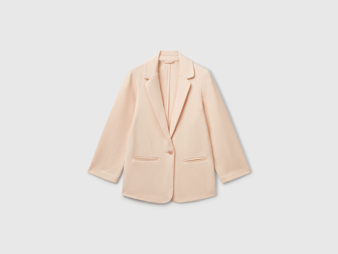 Front view of a chic light peach elegant long blazer for women, featuring a single-button closure and clean lines, a versatile wardrobe staple for Kuwait.