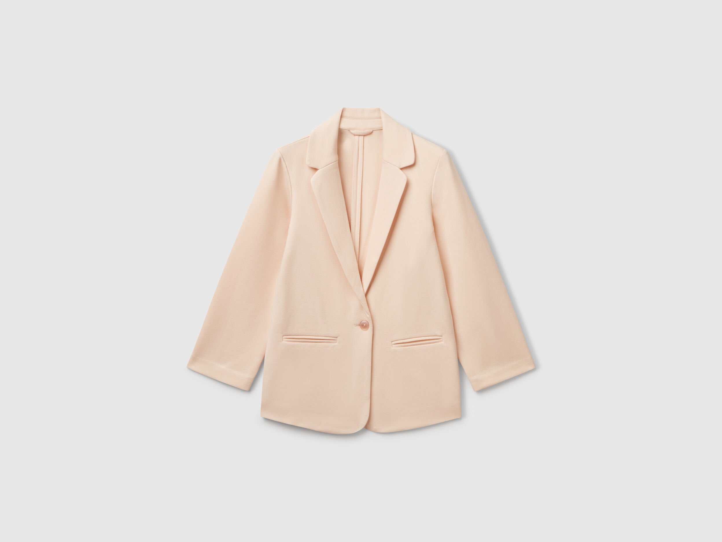Front view of a chic light peach elegant long blazer for women, featuring a single-button closure and clean lines, a versatile wardrobe staple for Kuwait.