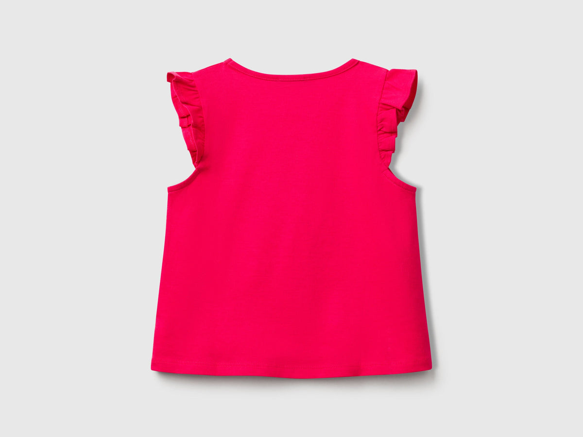 Back view of a plain fuchsia Benetton tank top with delicate ruffle details on the shoulders.