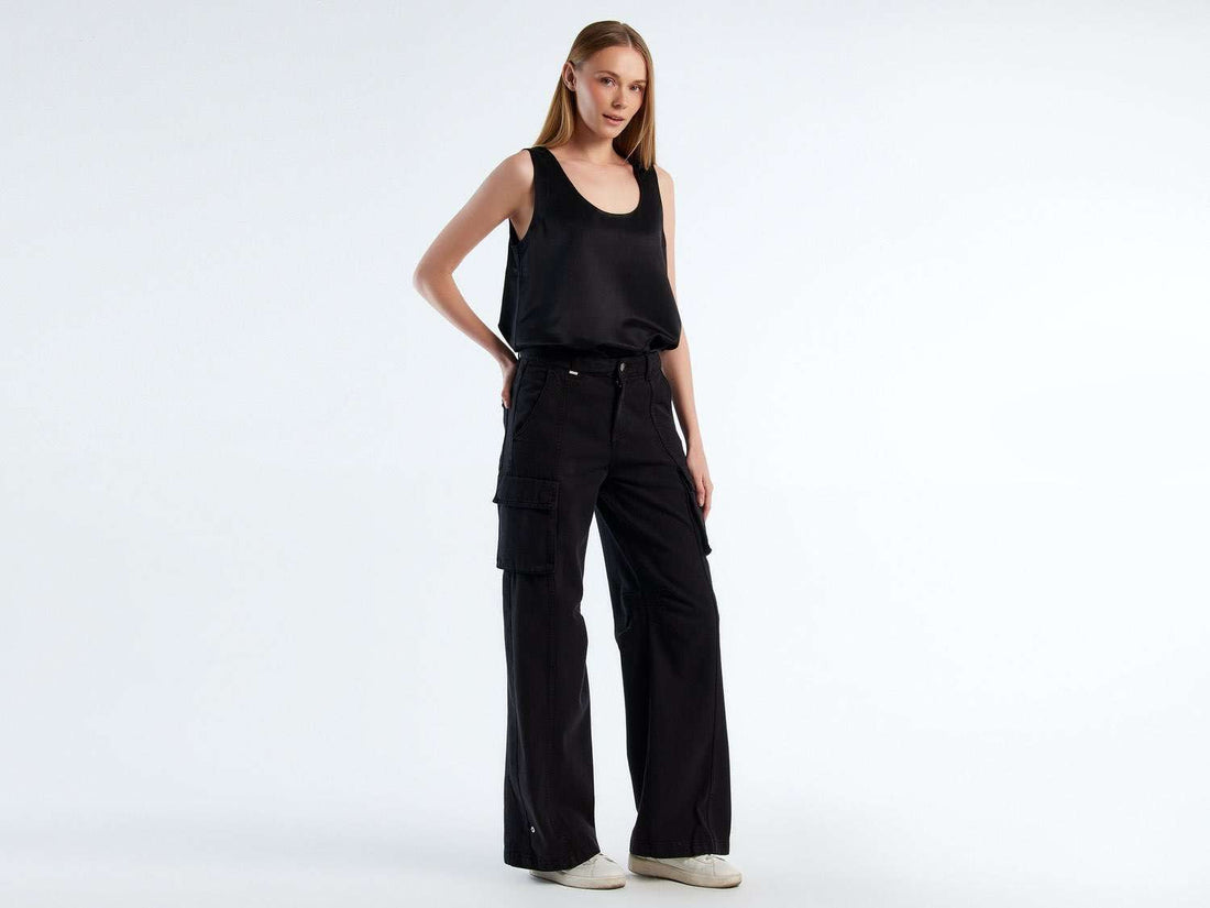 Front view of a pair of stylish cargo pants for girls, with visible side pockets.