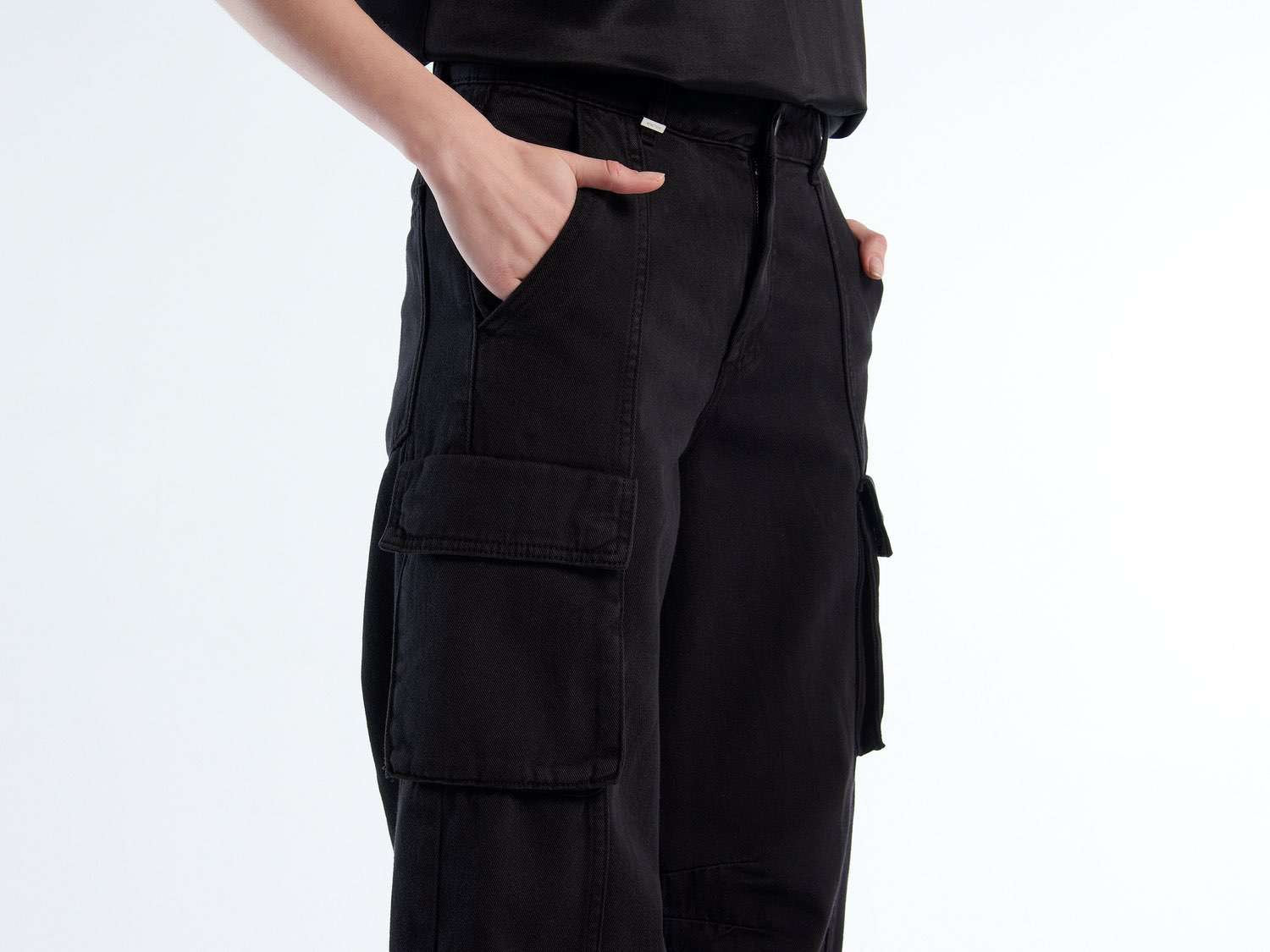 Side view detail of cargo pants for girls, highlighting the pocket and seam design.