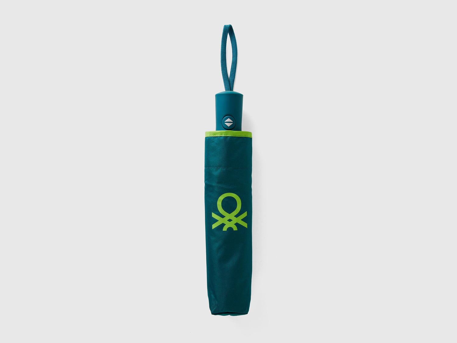 Folded green Benetton umbrella, compact for portability.