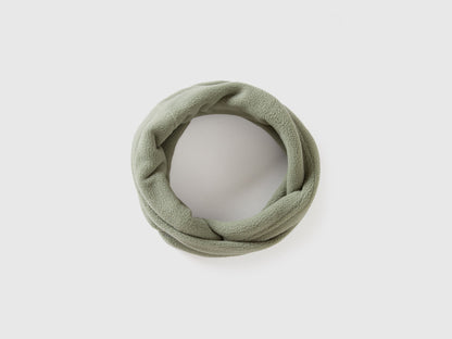 Green fleece neck warmer, rolled for comfort and warmth.