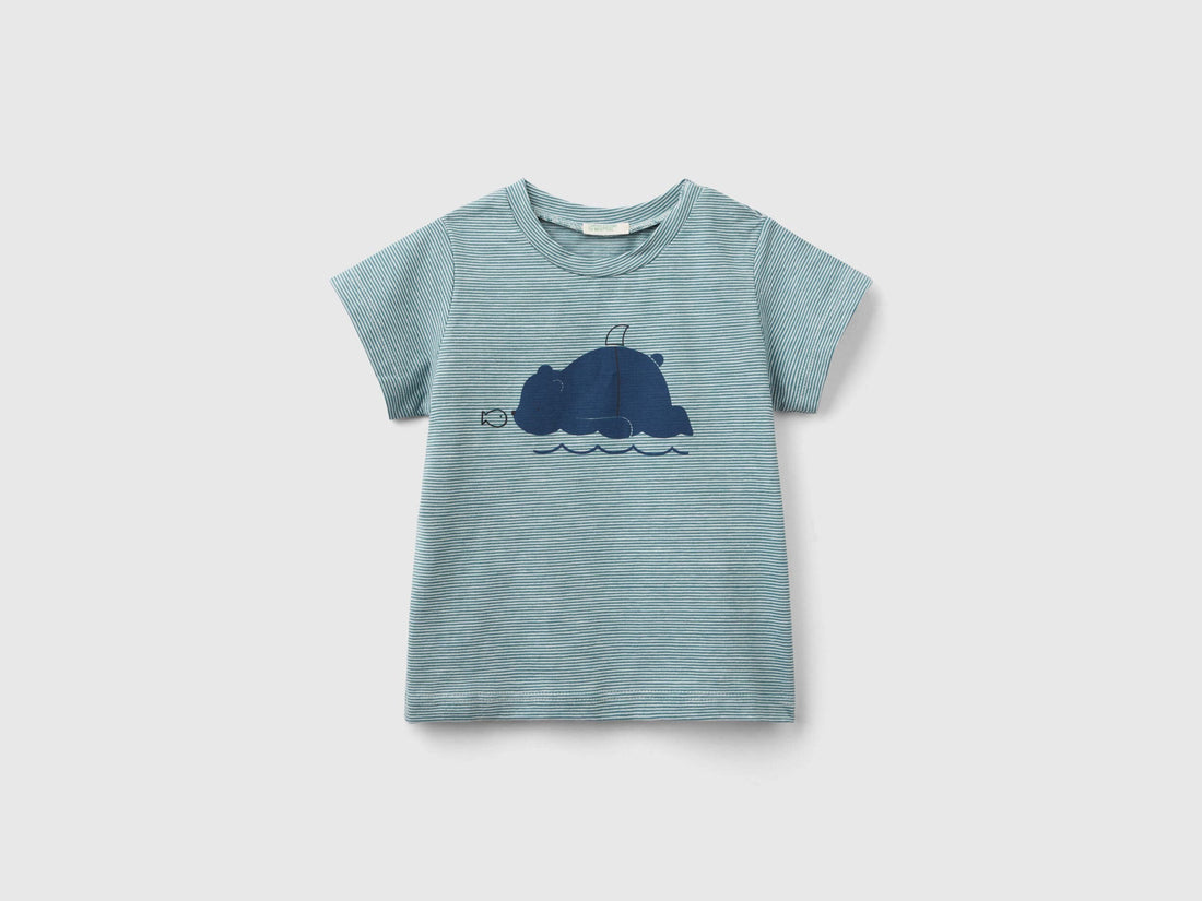 A young boy wearing a green kids&