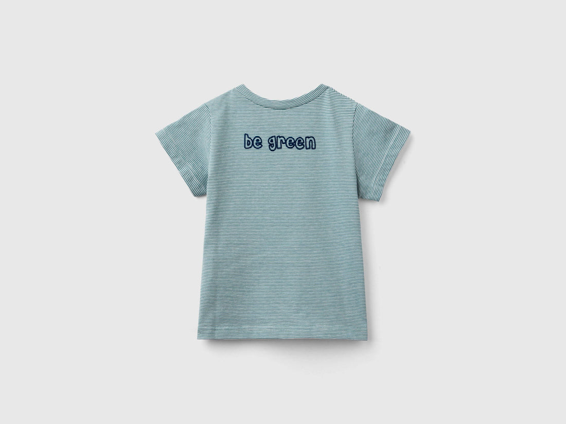 Side view of a young boy wearing a green kids&