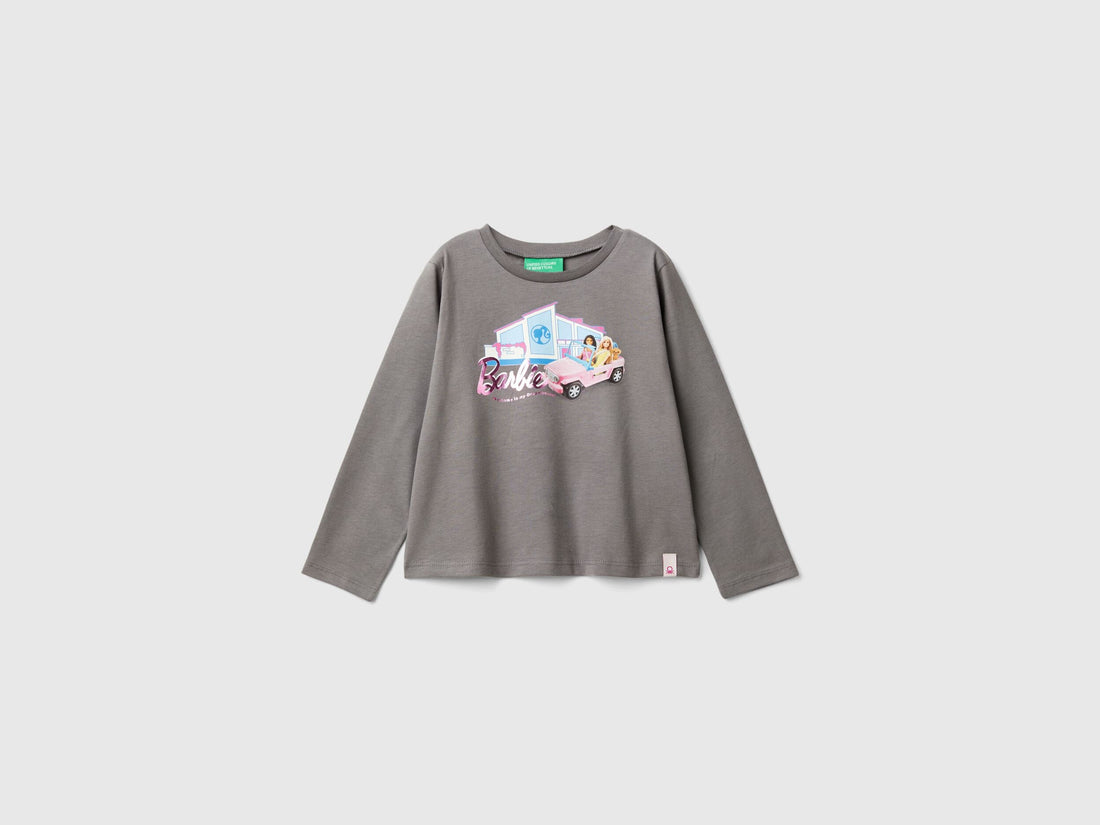 Close-up of the grey long-sleeve t-shirt hem, showing a small Benetton tag.