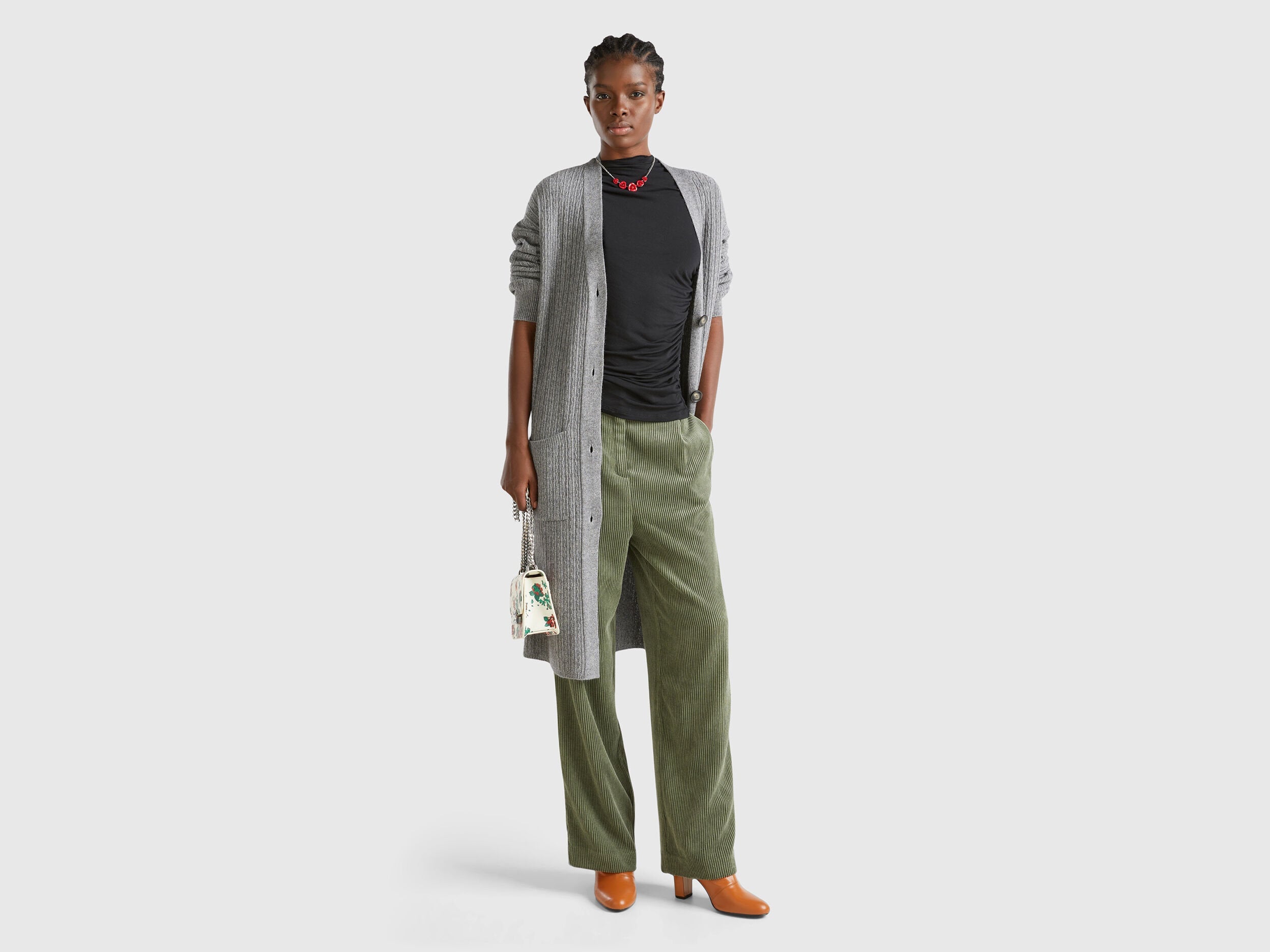 Front view: Woman in open grey long cardigan (wool blend) with black top &amp; olive wide-leg pants.