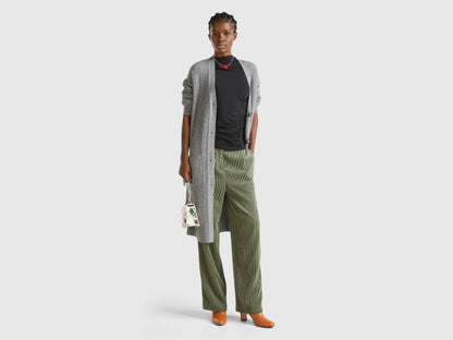 Front view: Woman in open grey long cardigan (wool blend) with black top &amp; olive wide-leg pants.