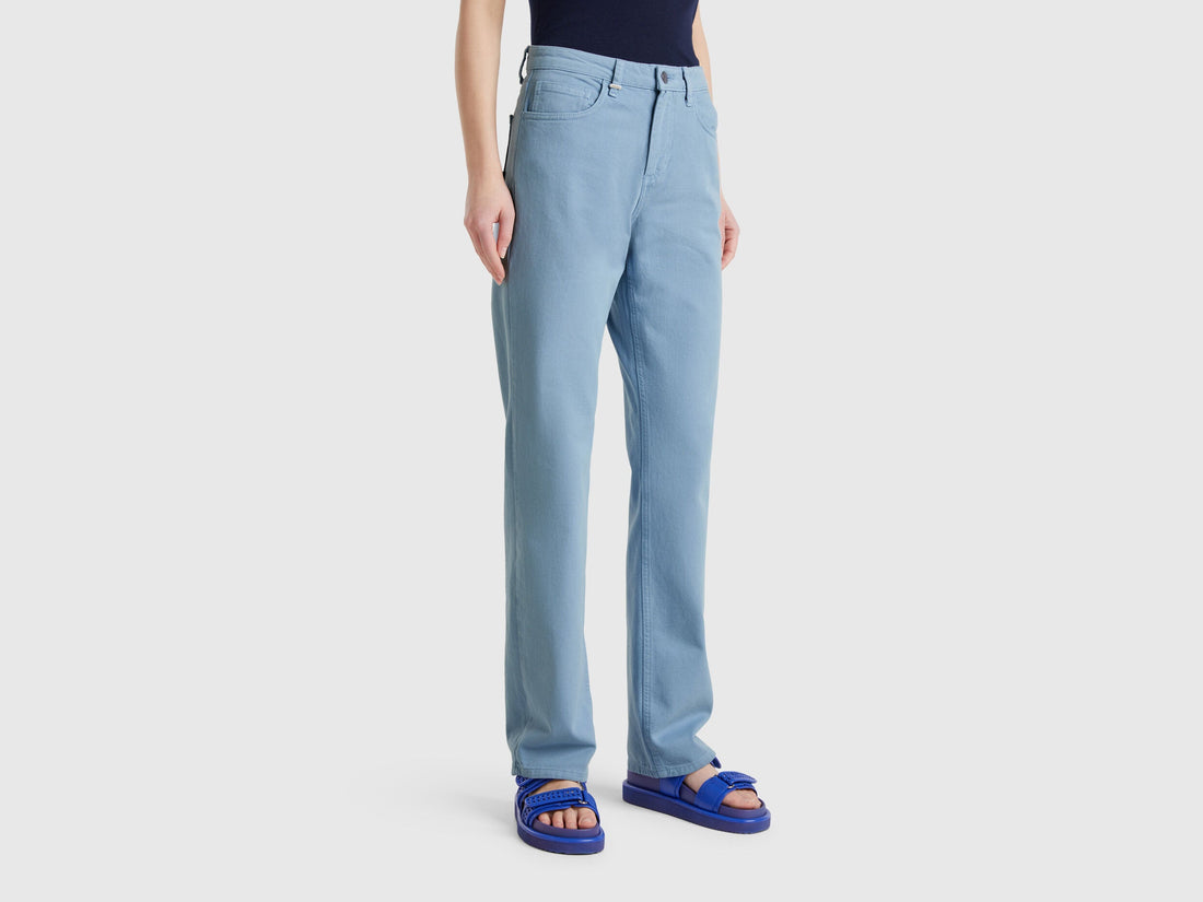 Side view of a female model wearing light blue women straight leg jeans in blue colour, highlighting the flattering fit and classic design, popular in Kuwait.