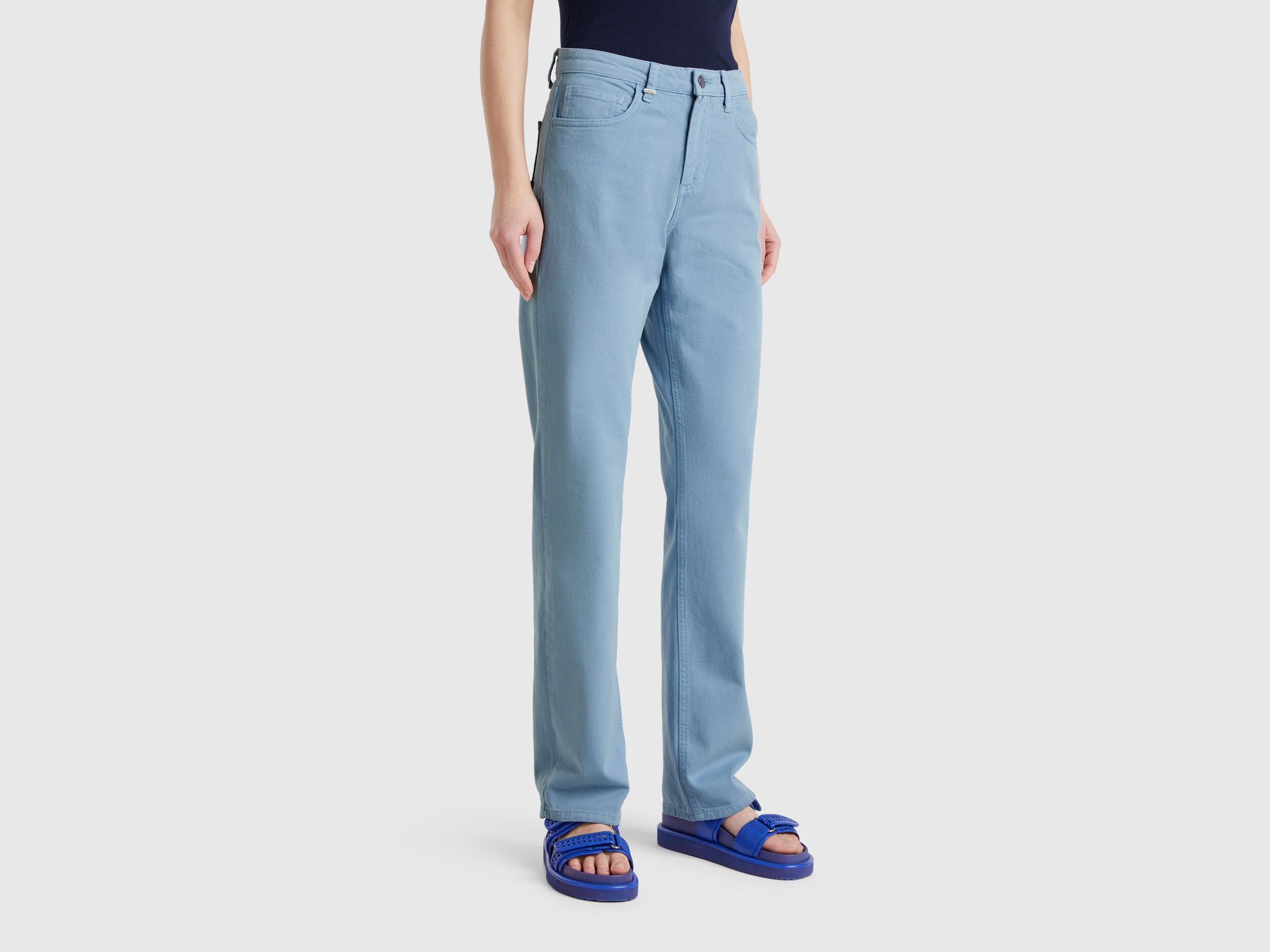 Side view of a female model wearing light blue women straight leg jeans in blue colour, highlighting the flattering fit and classic design, popular in Kuwait.