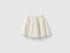 Front view of a whimsical cream-colored tulle skirt for kids, featuring multiple ruffled layers.
