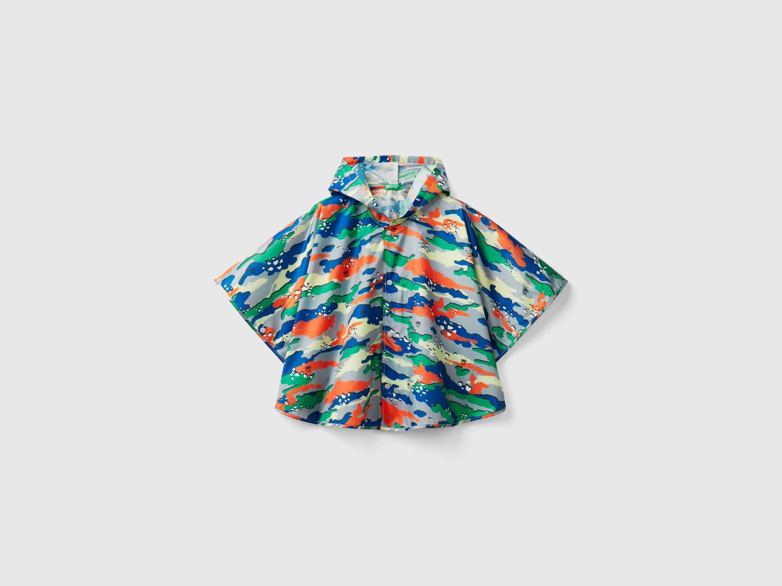 Front view of a colorful patterned rain poncho for kids, featuring a vibrant abstract design.