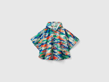 Front view of a colorful patterned rain poncho for kids, featuring a vibrant abstract design.