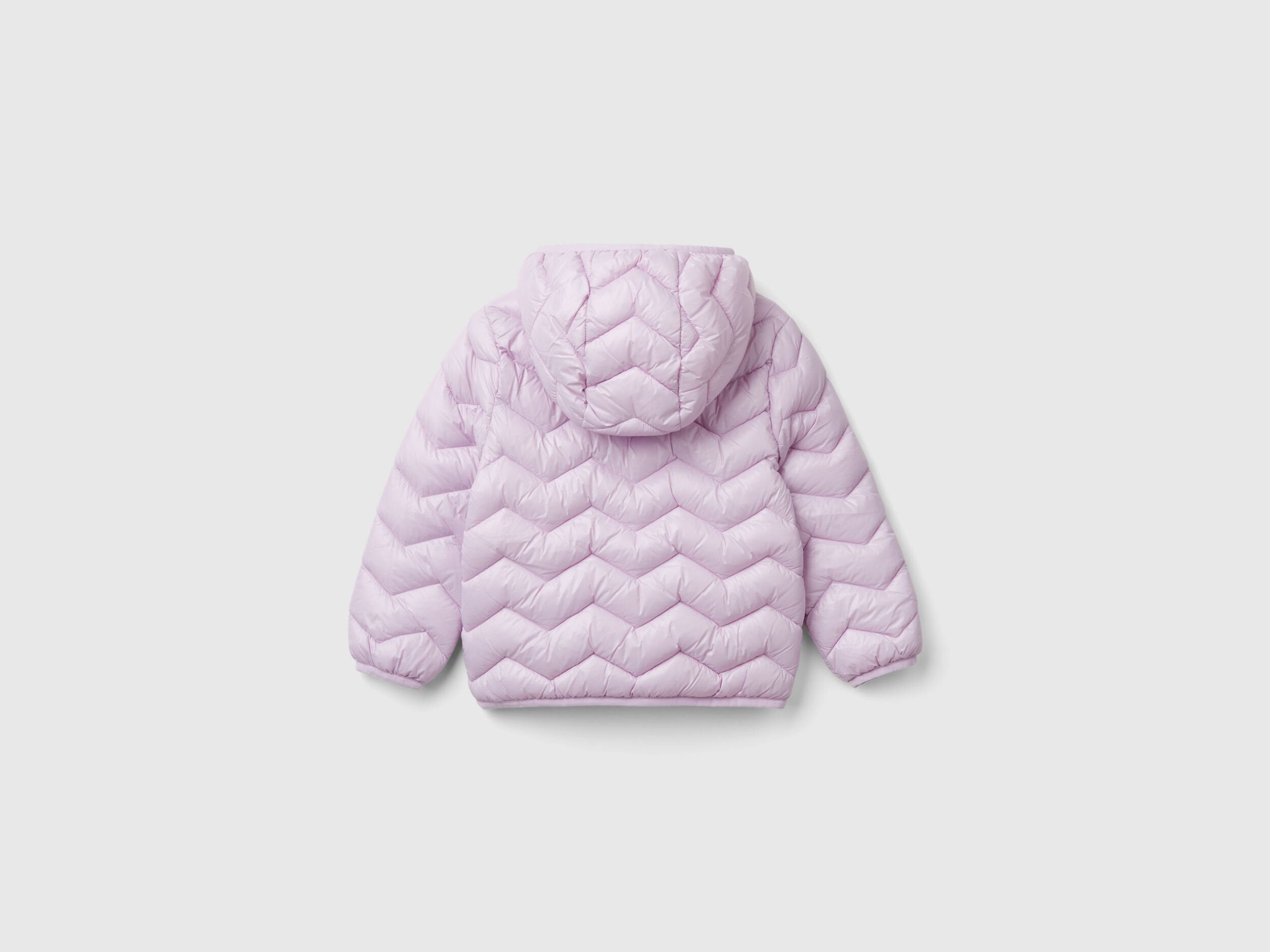 Back view of a light pink padded jacket with a hood for a girl.