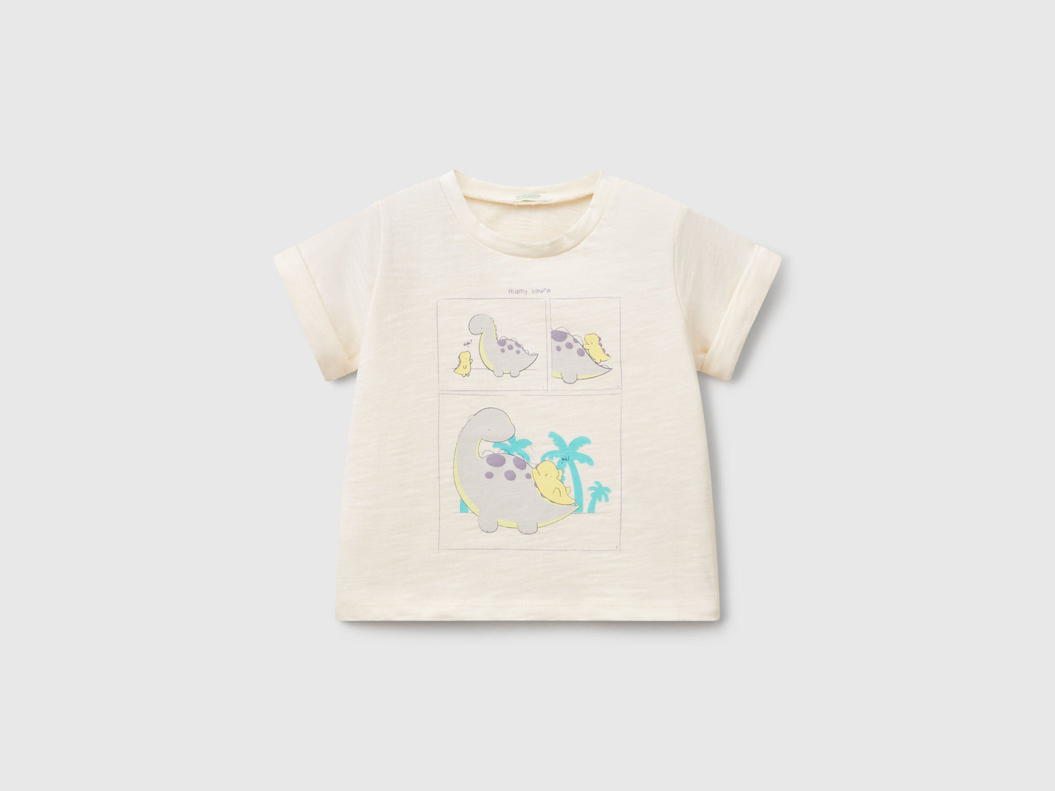 Front view of an off-white T-shirt for kids in Kuwait, featuring adorable graphic prints of cartoon dinosaurs and a palm tree, perfect for casual wear.