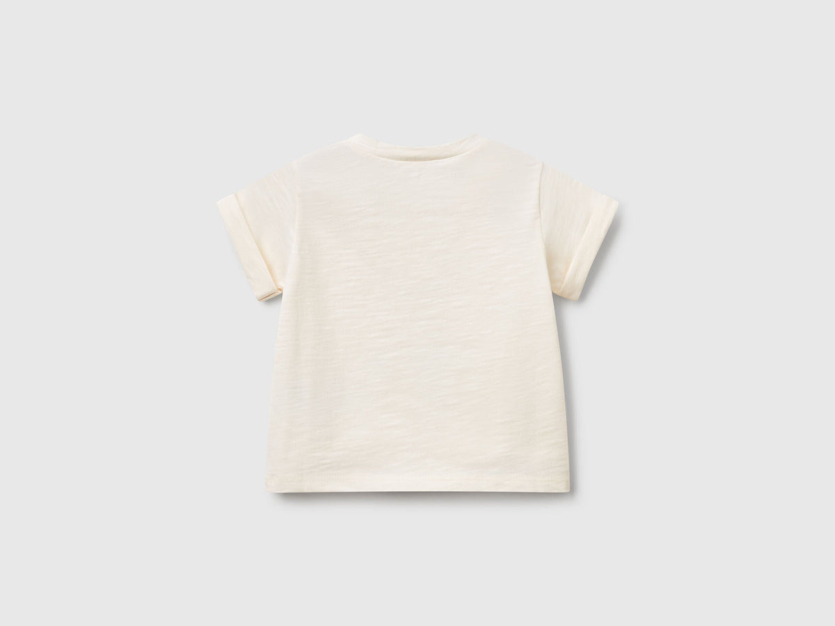 Back view of an off-white short-sleeve T-shirt for kids in Kuwait, showing its plain design and comfortable fit, ideal for everyday play.