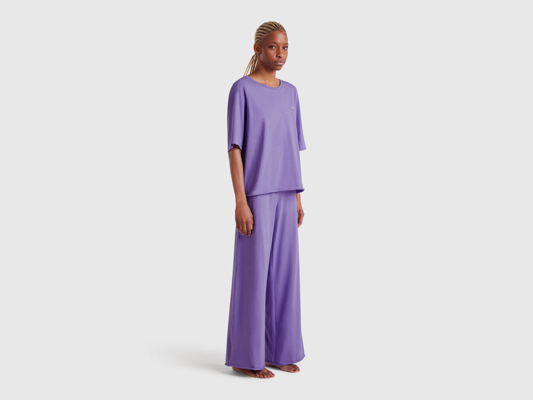 Front view of a model wearing a set of pure cotton, loose-fitting lavender womens pyjamas, showcasing their relaxed and comfortable design for sleep or lounging in Kuwait.