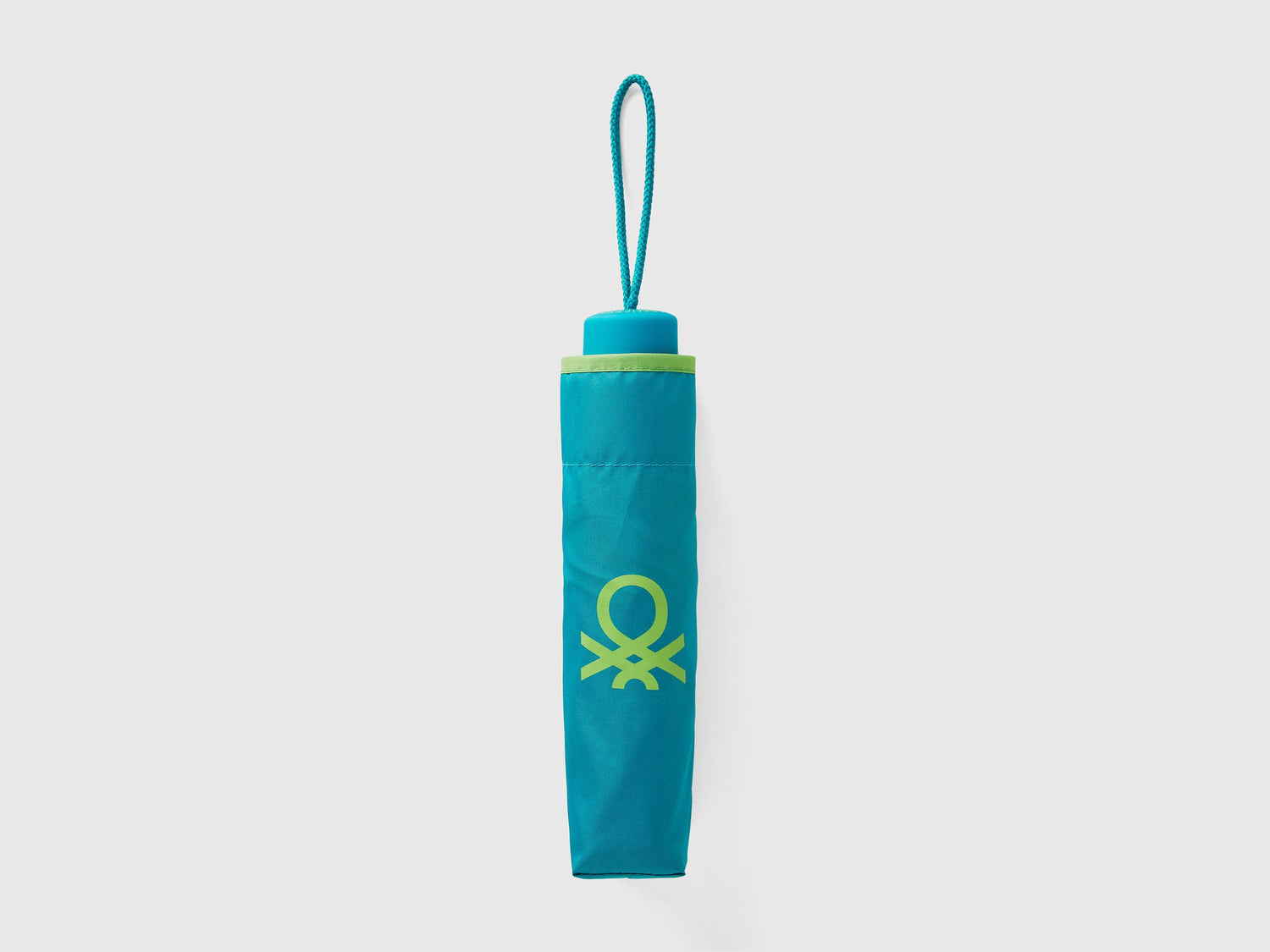 Folded light green Benetton umbrella, compact and portable.