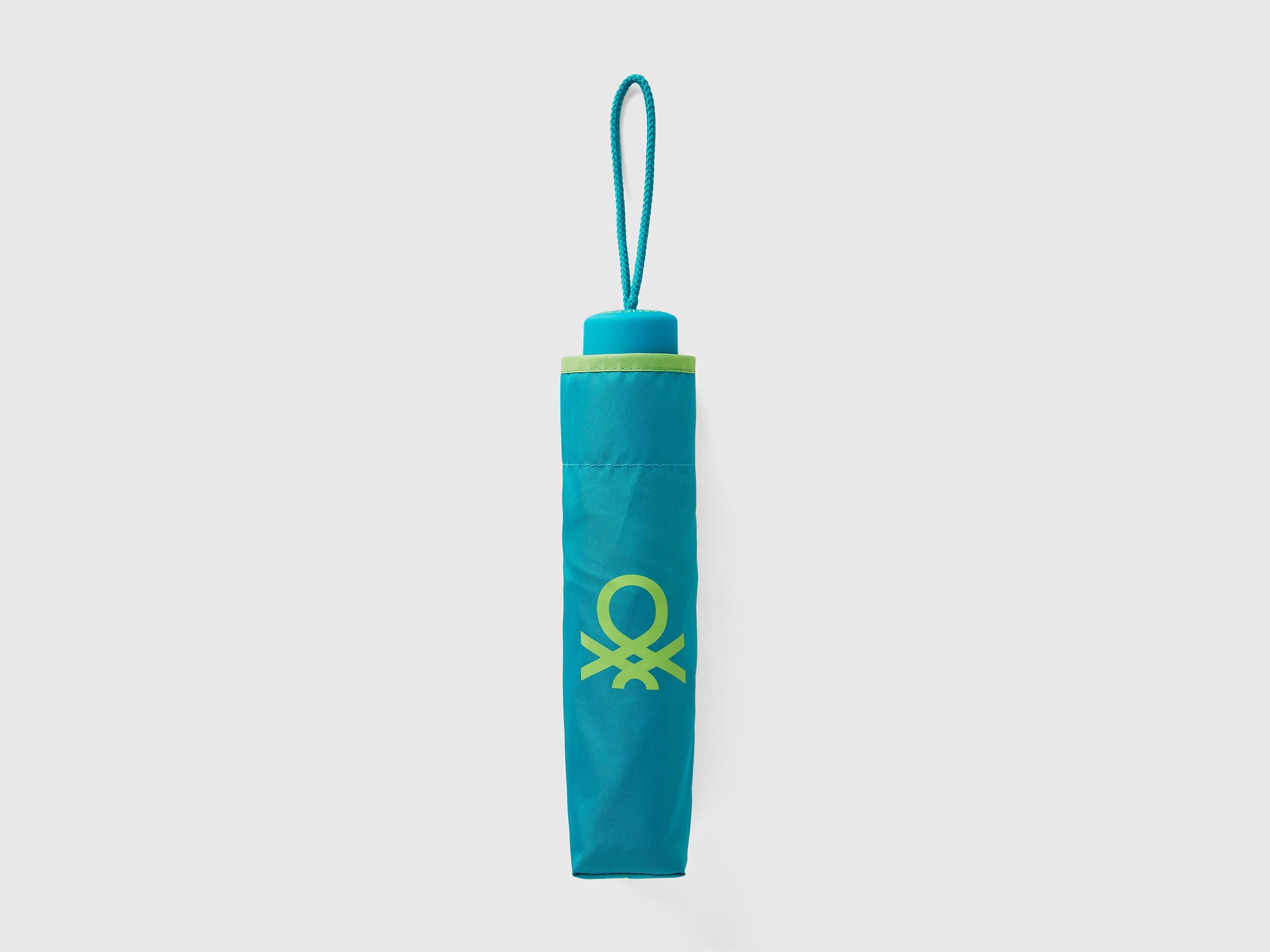 Folded light green Benetton umbrella, compact and portable.