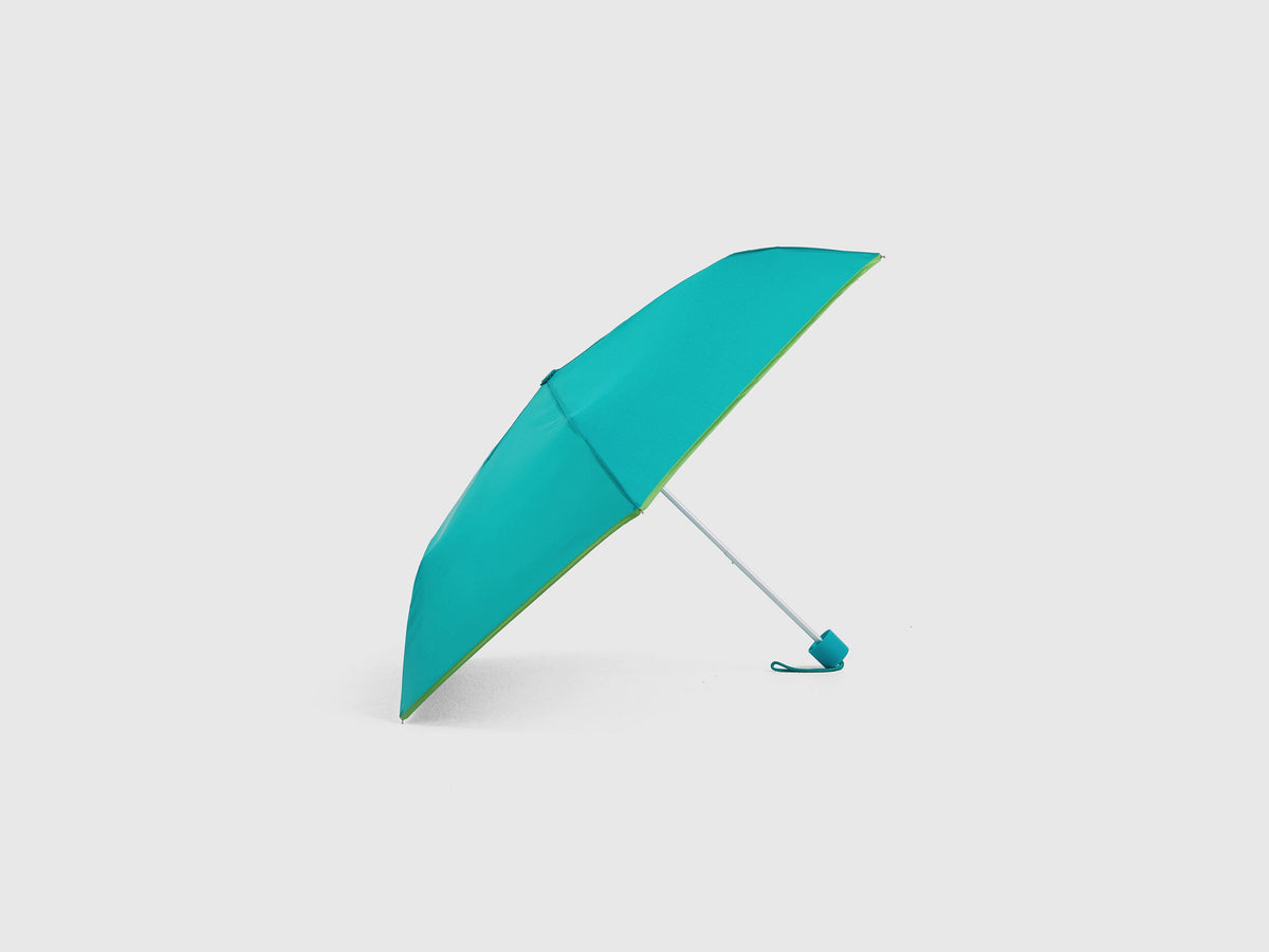 Light green Benetton umbrella, partially open, sleek design.