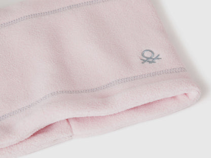 Close-up light pink fleece neck warmer with Benetton logo.