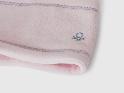 Close-up light pink fleece neck warmer with Benetton logo.