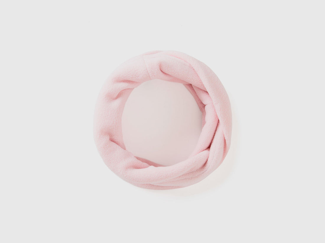 Light pink fleece neck warmer, rolled for soft comfort.