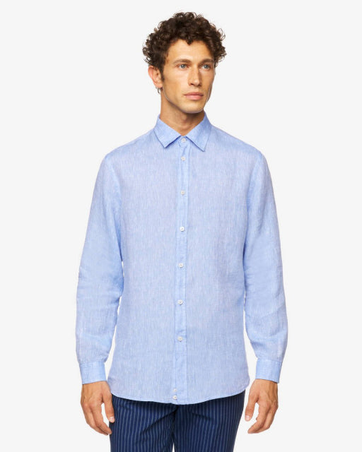 Front view of a male model wearing a light blue long-sleeve linen shirt, featuring a classic design, a popular choice for linen shirts in Kuwait.