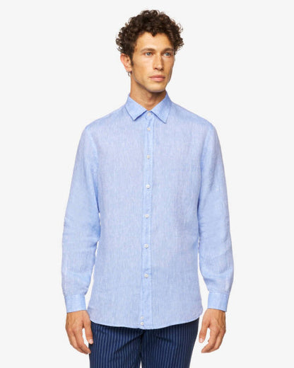 Front view of a male model wearing a light blue long-sleeve linen shirt, featuring a classic design, a popular choice for linen shirts in Kuwait.