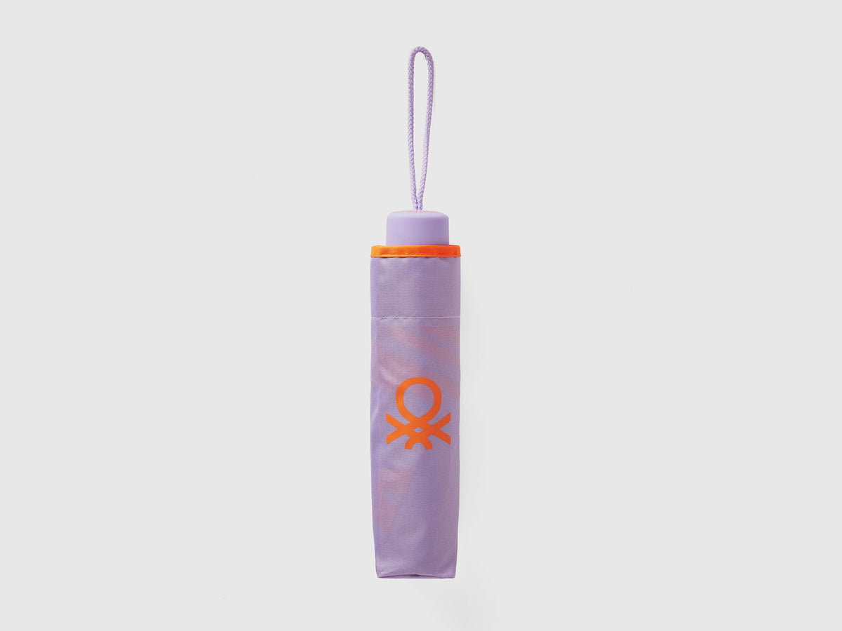 Folded lilac Benetton umbrella, compact for portability.