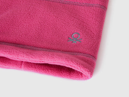 Close-up of magenta fleece neck warmer with Benetton logo.