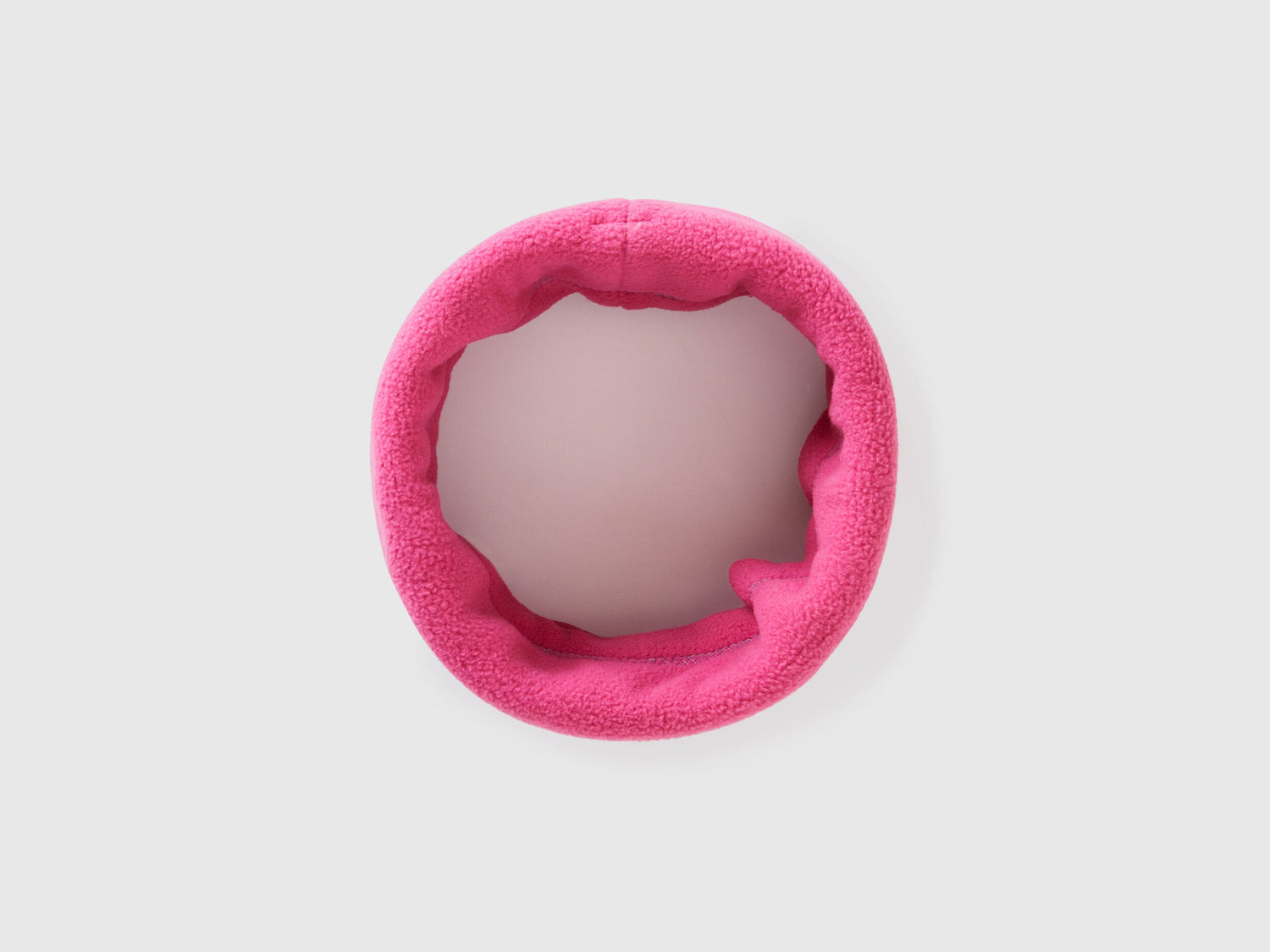 Magenta fleece neck warmer, rolled for warmth and style.