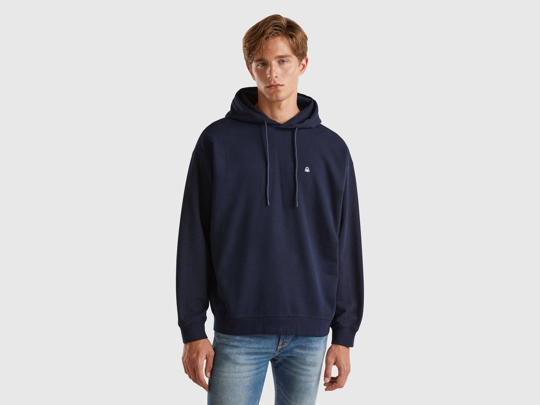 Front view of a man wearing a royal blue 100% cotton hoodie.